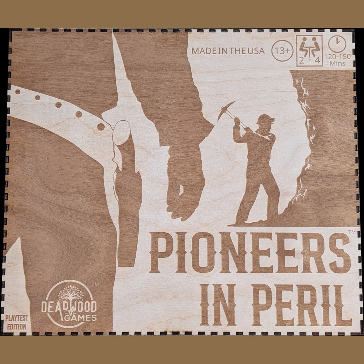 Pioneers in Peril box cover — laser-etched wooden board game by Deadwood Games